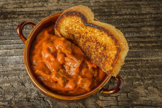 Bowl of homemade steak chili served with toast.