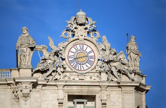 Maderno's facade with the clock between two statues, St. Peter's Basilica. Vatican City, Rome, Italy