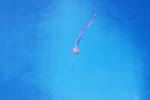 Colorful kite flying in the wind, textured artwork in painting style