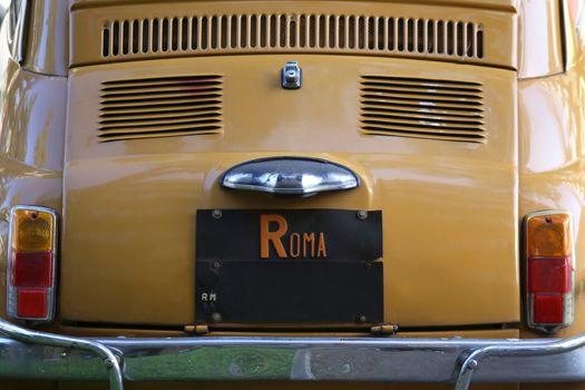 Old car at the city street parked in Rome, Italy