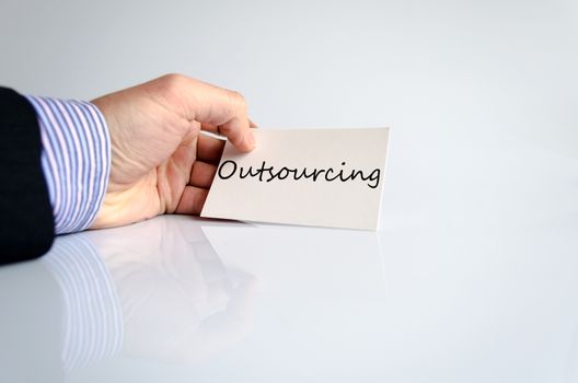 Business man hand writing Outsourcing over white background