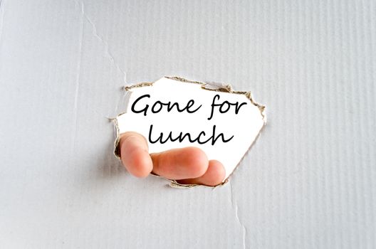 Hand and text on the cardboard background Gone for lunch concept