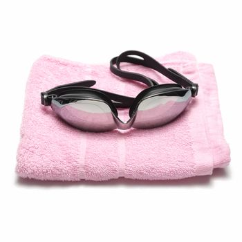 towel and swimming goggles isolated on white background