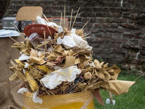 overfull food garbage can trash during a traditional village festival