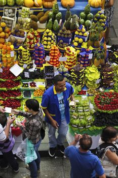 SAO PAULO/BRAZIL - MAY 9: An unidentified vendor at a fruit stand in Central Market of Sao Paulo on May 09, 2015. This landmark is a destination for tourists and locals.