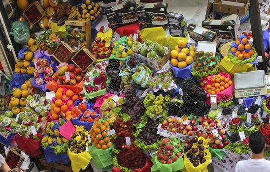 SAO PAULO/BRAZIL - MAY 9: An unidentified vendor at a fruit stand in Central Market of Sao Paulo on May 09, 2015. This landmark is a destination for tourists and locals.