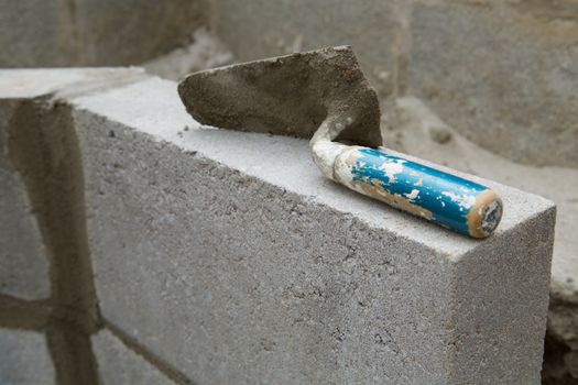 Yellow spirit level on a constructed wall outdoors