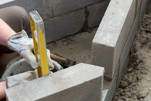Yellow spirit level on a constructed wall outdoors