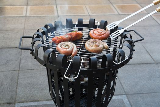 Cooking tasteful meat on a barbecue outside during winter