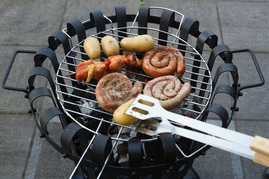 Cooking tasteful meat on a barbecue outside during winter