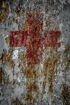 A First Aid Red Cross On A Grungy Rusty Texture Background