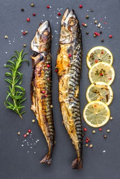 Baked Whole Mackerel Fish with Spice, Lemon and Rosemary on Grey Stone Overhead