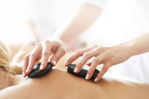 woman having stone therapy at spa session