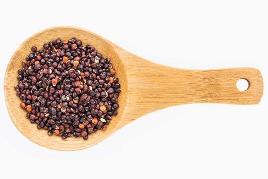 gluten free, black quinoa grain on a small wooden spoon isolated on white with a clipping path