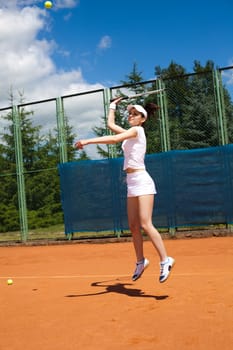 Girl playing tennis on the court