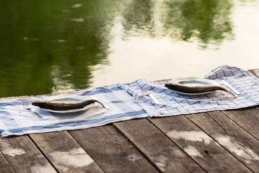 Wooden deck with fish on it at the lake