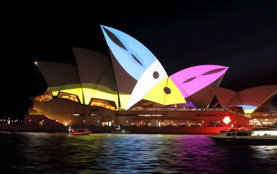 SYDNEY, AUSTRALIA - MAY 23, 2015; Sydney Opera House illuminated with colourful animated imagery during the Vivid Sydney 2015 annual public event. Here, two toucans chirp
