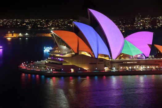 SYDNEY, AUSTRALIA - MAY 23, 2015; Sydney Opera House illuminated with colourful animated imagery during the Vivid Sydney 2015 annual public event.  Vivid solid colours of red, blue, pink, green and orange on display.
