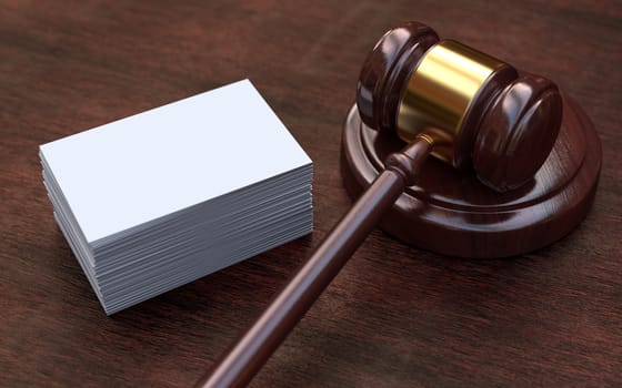 Judge, wooden gavel on the brown wooden background with white, blank business cards. Mockup