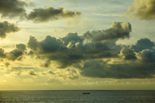 Lonely boat in the ocean before sunset