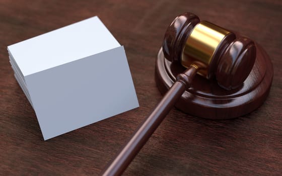 Judge, wooden gavel on the brown wooden background with white, blank business cards. Mockup