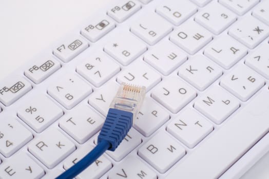 Computer keyboard with cable, close up view