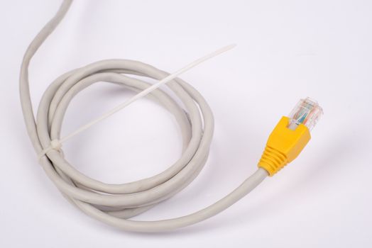 Twisted yellow computer cable on isolated white background