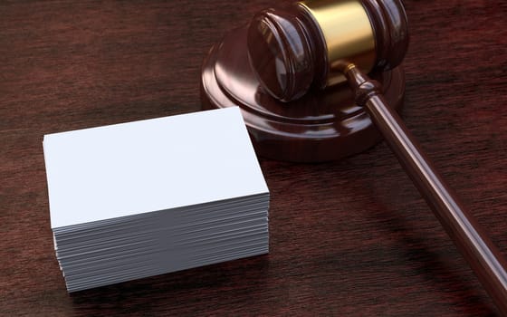 Judge, wooden gavel on the brown wooden background with white, blank business cards. Mockup