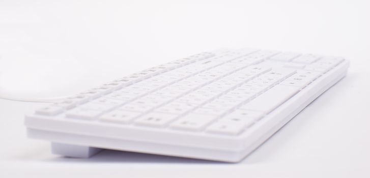 White keyboard with wire on isolated white background, different view