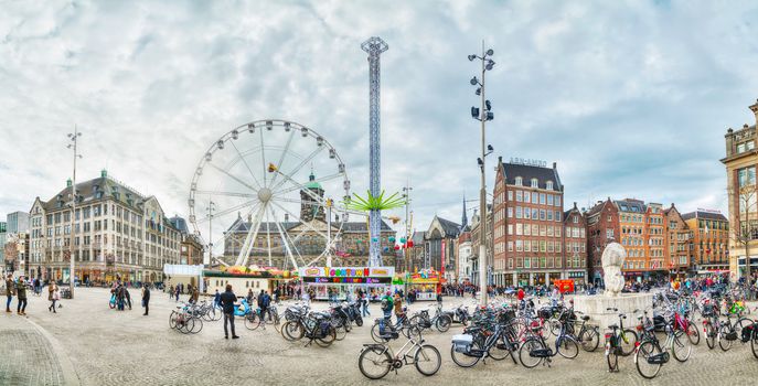 AMSTERDAM - APRIL 16: Dam square crowded with tourists on April 16, 2015 in Amsterdam, Netherlands. It's the capital city and most populous city of the Kingdom of the Netherlands.