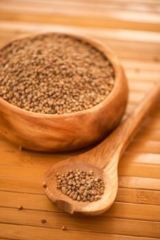 buckwheat at wooden plate on wooden background
