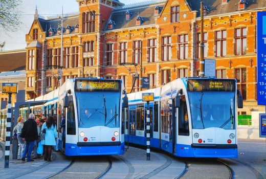 AMSTERDAM - APRIL 15: Trams at the Amsterdam Centraal railway station on April 15, 2015 in Amsterdam, Netherlands. It's is the largest railway station of Amsterdam and a major national railway hub.