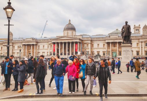 LONDON - APRIL 5: Trafalgar square on April 5, 2015 in London, UK. It's a public space and tourist attraction in central London, built around the area formerly known as Charing Cross.