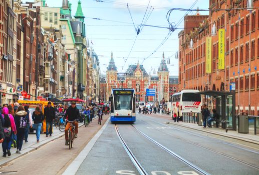 AMSTERDAM - APRIL 17: Tram near the Amsterdam Centraal railway station on April 17, 2015 in Amsterdam, Netherlands. It's is the largest railway station of Amsterdam and a major national railway hub.