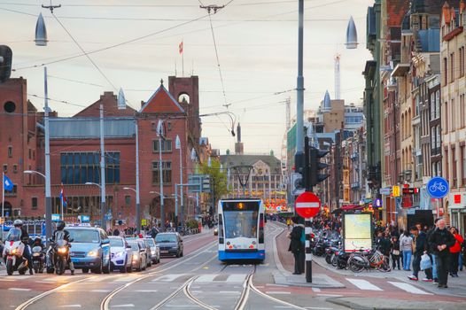 AMSTERDAM - APRIL 16: Tram near the Amsterdam Centraal railway station on April 16, 2015 in Amsterdam, Netherlands. It's is the largest railway station of Amsterdam and a major national railway hub.