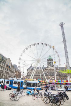 AMSTERDAM - APRIL 16: Dam square crowded with tourists on April 16, 2015 in Amsterdam, Netherlands. It's the capital city and most populous city of the Kingdom of the Netherlands.