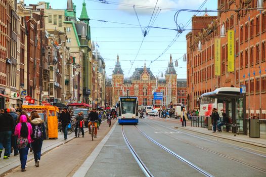 AMSTERDAM - APRIL 17: Tram near the Amsterdam Centraal railway station on April 17, 2015 in Amsterdam, Netherlands. It's is the largest railway station of Amsterdam and a major national railway hub.