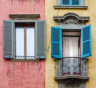 Italian house with colorful walls, windows and balcony in Bergamo, Lombardia, Italy