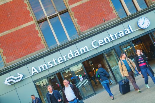 AMSTERDAM - APRIL 16: Entrance to the Amsterdam Centraal railway station on April 16, 2015 in Amsterdam, Netherlands. It's is the largest railway station of Amsterdam and a major national railway hub.
