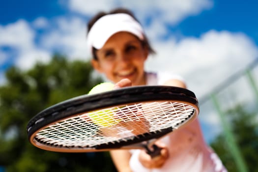 Girl playing tennis on the court