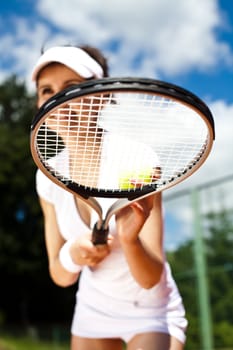 Girl playing tennis on the court