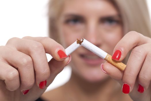 Close up Young Blond Woman Breaking a Cigarette Stick Using her Bare Hand on a White Background.