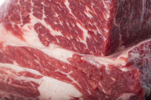 Fresh Slice of Protein Rich Raw Beef Meat on Top of the Table on White Background