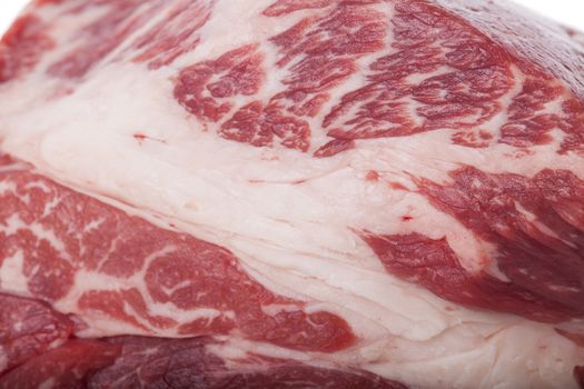 Fresh Slice of Protein Rich Raw Beef Meat on Top of the Table on White Background