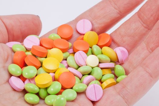 multicolored medical pills on hand