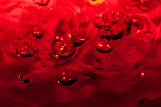 red abstract background with water drops on glass for background or backdrop