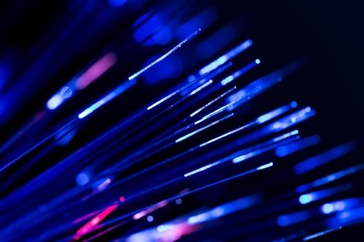 bunch of optical fibres flying from deep as blurred abstract technology background