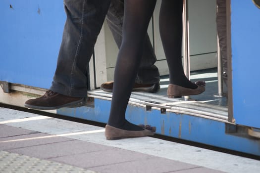 during a train stop a girl climbs into the car while a man down