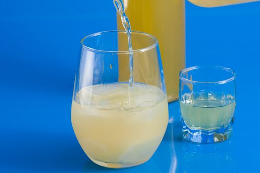 Italian alcoholic drink served in a glass on a light blue background