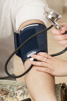 Female Doctor uses a sphygmomanometer